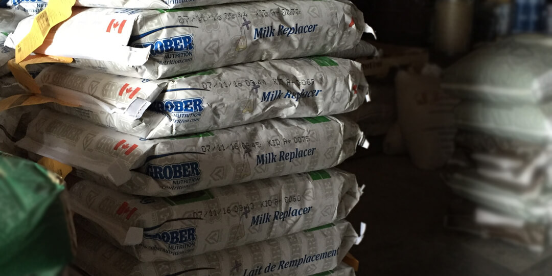 Grober milk replacer stacked on pallet in storage