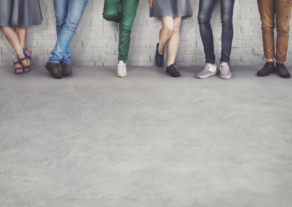 People leaning against a wall